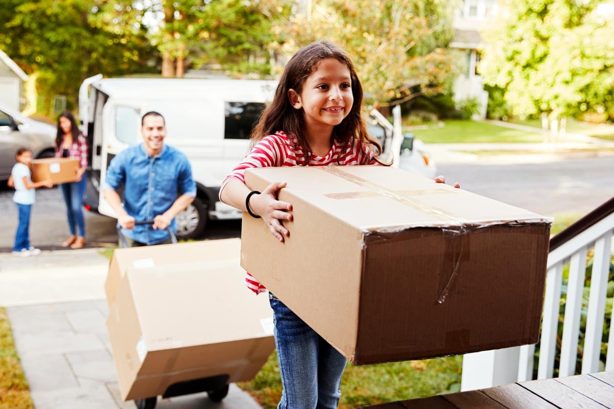 girl_carrying_box_into_new_home
